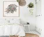 bird watercolor painting with flowers, framed and hanged in a white bedroom