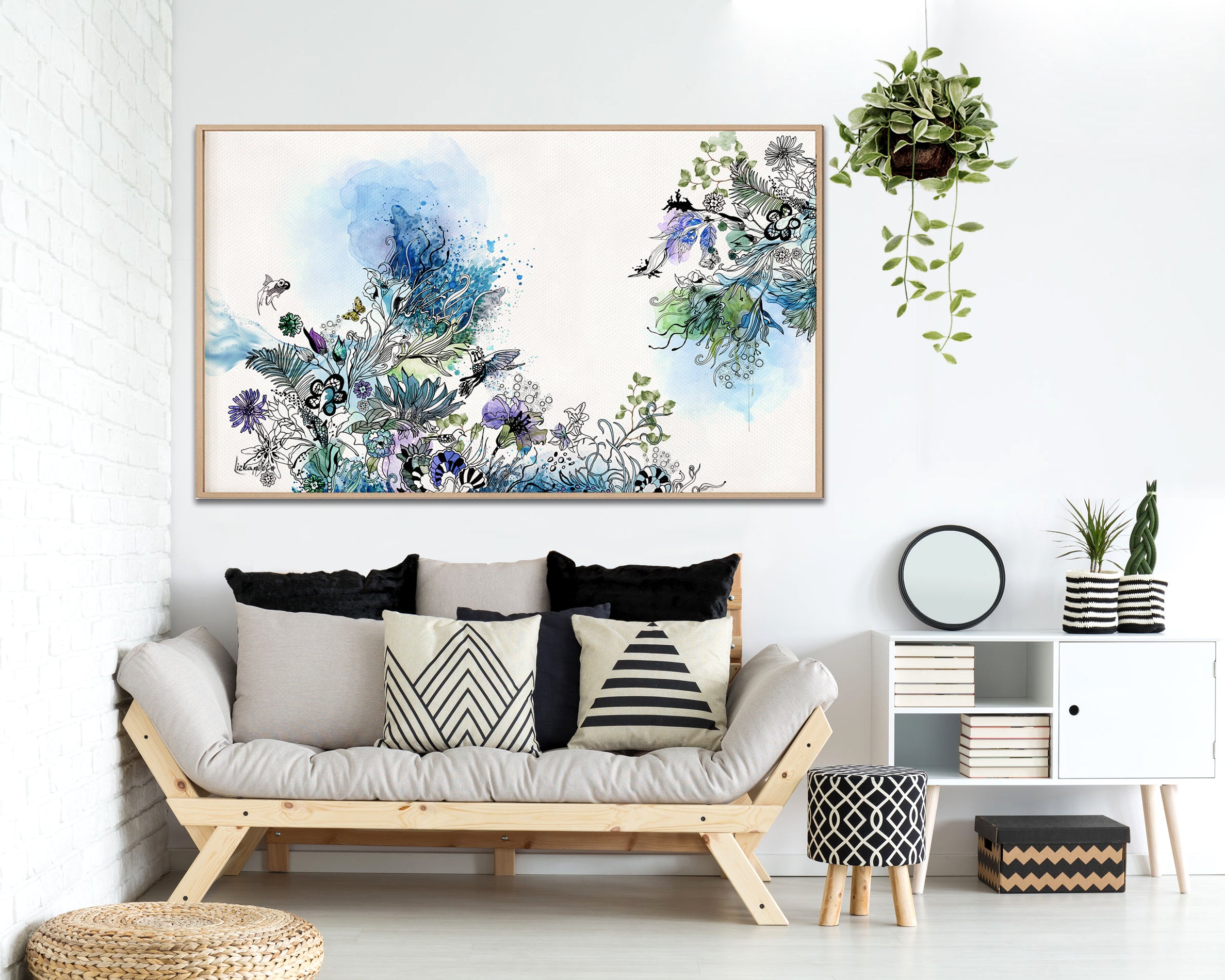 Blue watercolor painting above modern couch