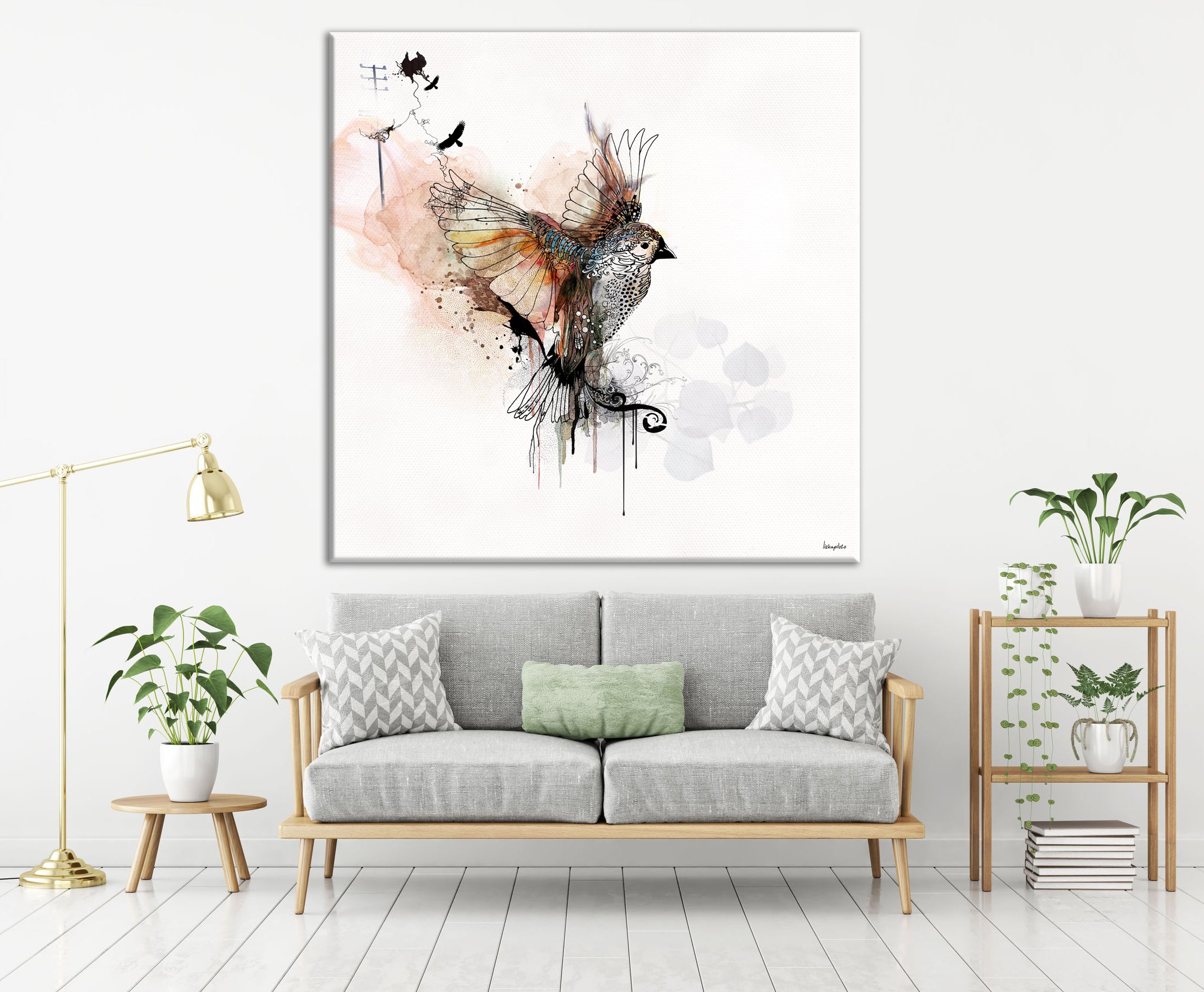 Flying bird art, hanged on a white wall, above a gray sofa