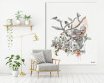 Large deer wall art on canvas, hanged on a white wall above a gray couch