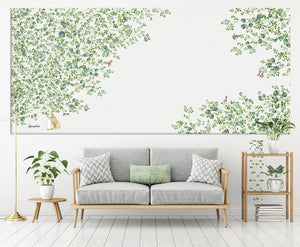 Panoramic wall art of green leaves painting, above gray sofa
