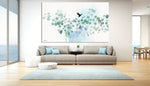 Nordic wall art of turquoise watercolor leaves, hanged in a modern living room above the sofa